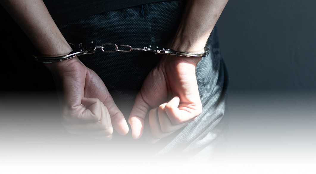 a person in handcuffs shown from behind