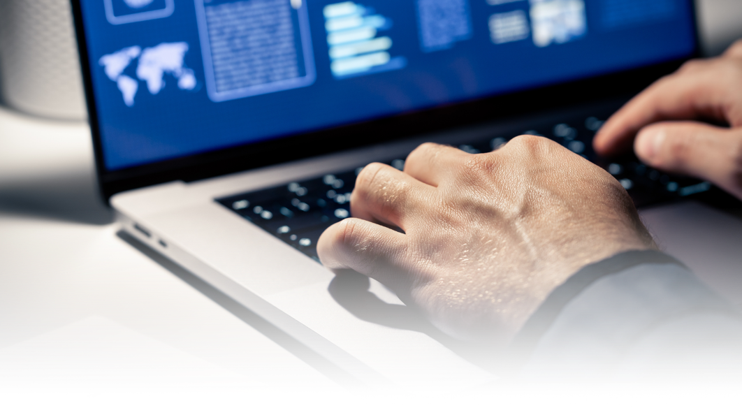 a person's hands typing on a computer